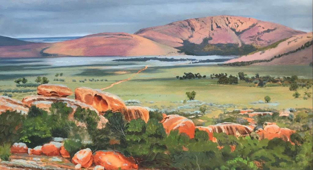 Oil on canvas depiction of an immense plain viewed over red Central Australian boulders